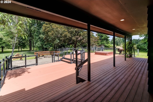 wooden deck featuring a jacuzzi