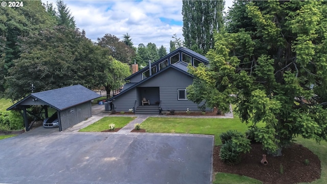 view of front facade with a carport and a front yard