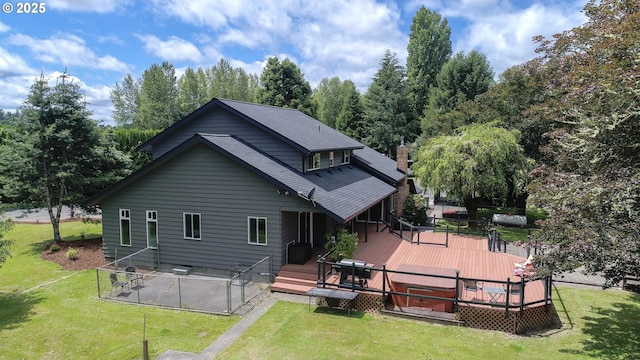 back of house with a deck and a yard