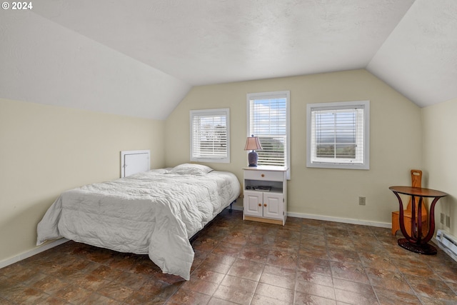 bedroom with a textured ceiling and vaulted ceiling