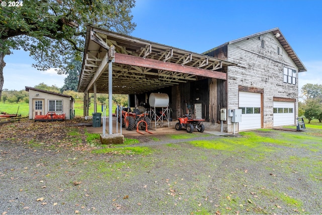 exterior space featuring a garage and a wooden deck