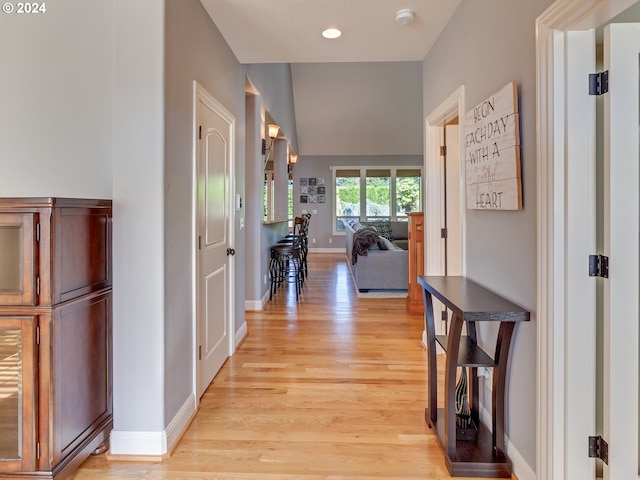 corridor with light hardwood / wood-style floors