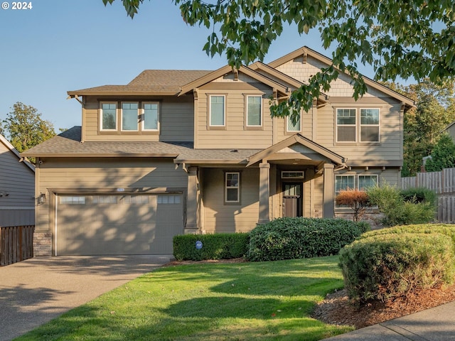 craftsman house with a garage and a front lawn