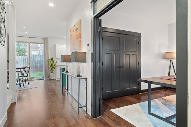 corridor with dark hardwood / wood-style flooring