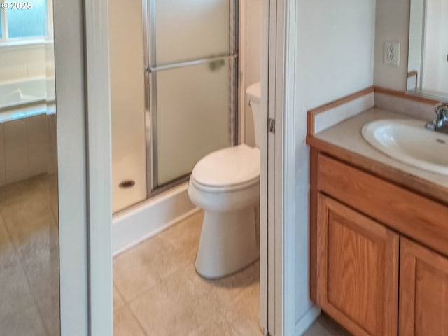 bathroom with vanity, toilet, and a shower with shower door