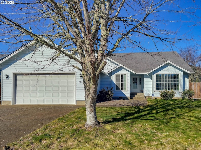 ranch-style home featuring a garage and a front yard