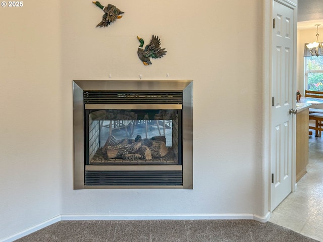 room details featuring an inviting chandelier and carpet floors