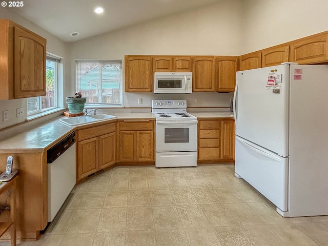 kitchen featuring lofted ceiling, sink, and white appliances