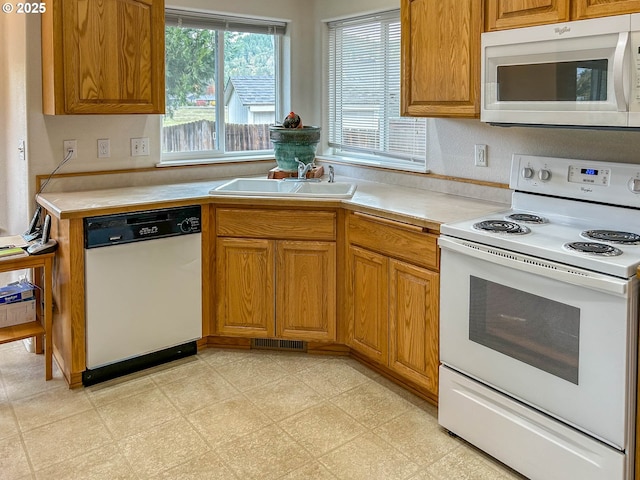 kitchen featuring white appliances and sink