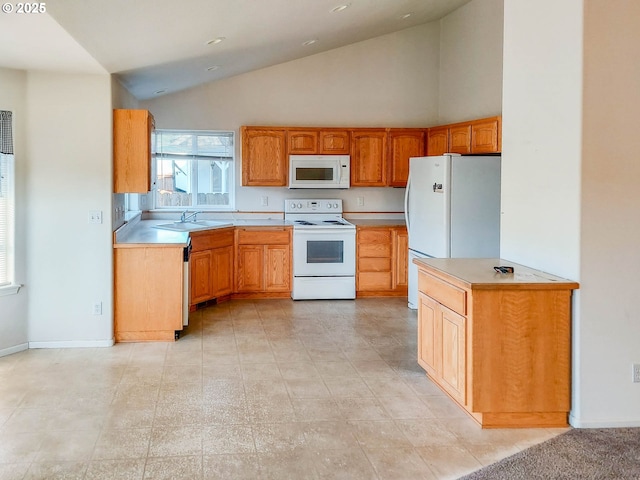 kitchen with high vaulted ceiling, sink, and white appliances