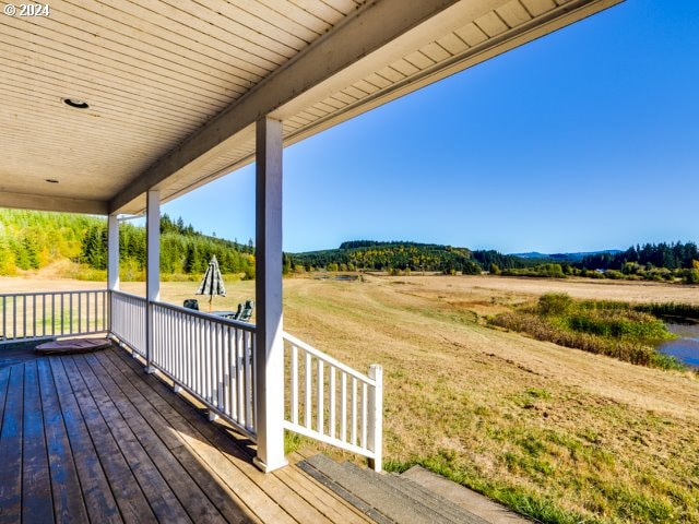 wooden deck with a rural view