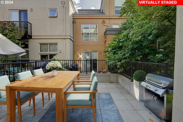 view of patio featuring fence and outdoor dining area