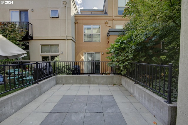 view of patio featuring a balcony