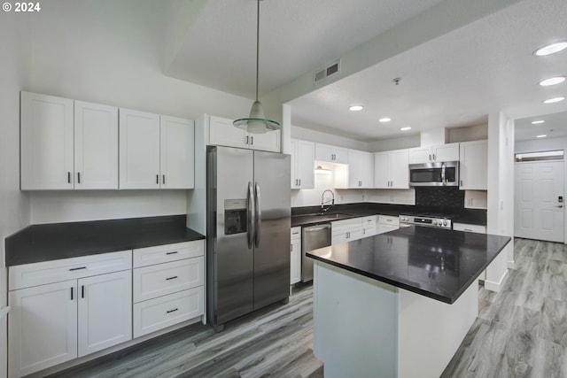 kitchen featuring light wood-style floors, white cabinetry, visible vents, appliances with stainless steel finishes, and a sink