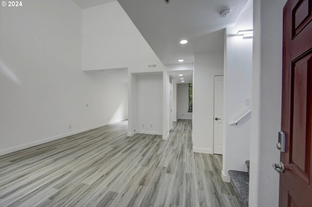 interior space featuring visible vents, baseboards, recessed lighting, and light wood-style floors