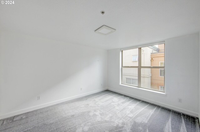 empty room featuring baseboards and carpet floors