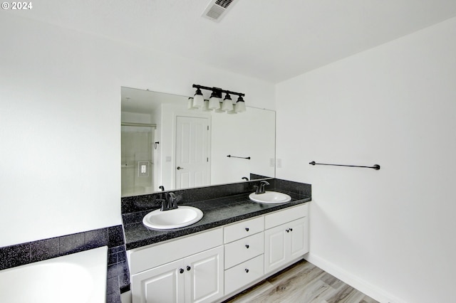 bathroom with vanity, shower with separate bathtub, and hardwood / wood-style flooring