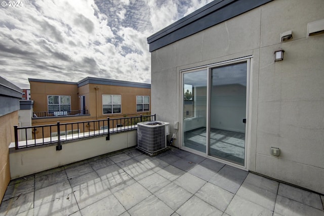 view of patio featuring cooling unit and a balcony