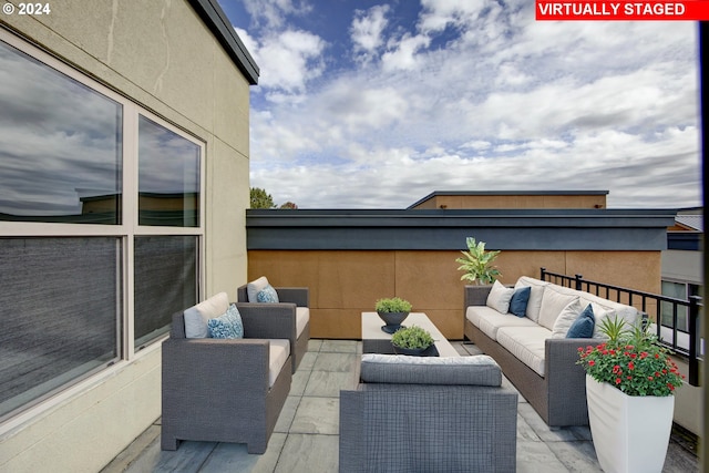 view of patio / terrace with a balcony and outdoor lounge area