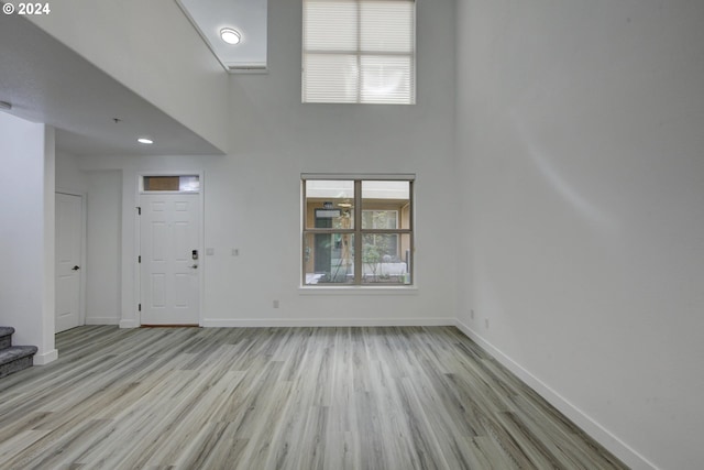 foyer with a high ceiling and light wood-type flooring