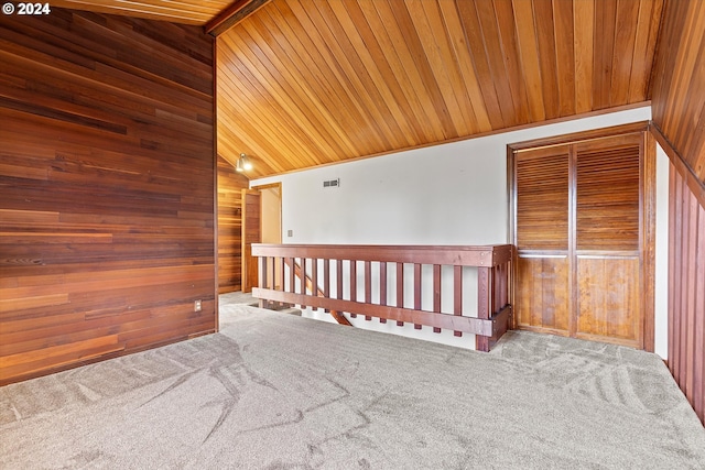 unfurnished room featuring wood walls, carpet floors, wooden ceiling, and lofted ceiling