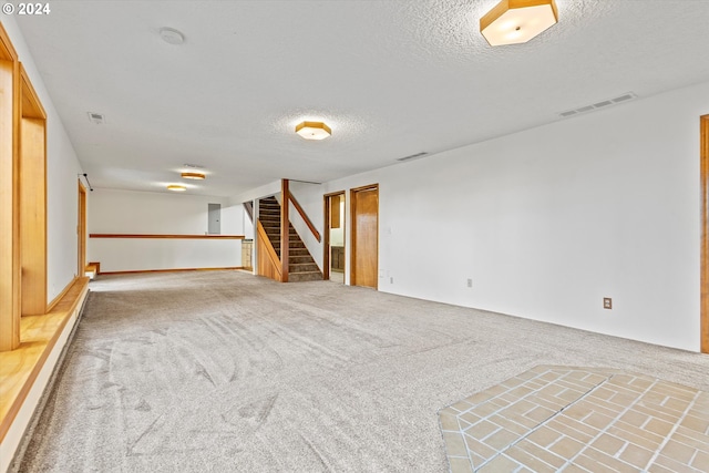 interior space with carpet flooring and a textured ceiling