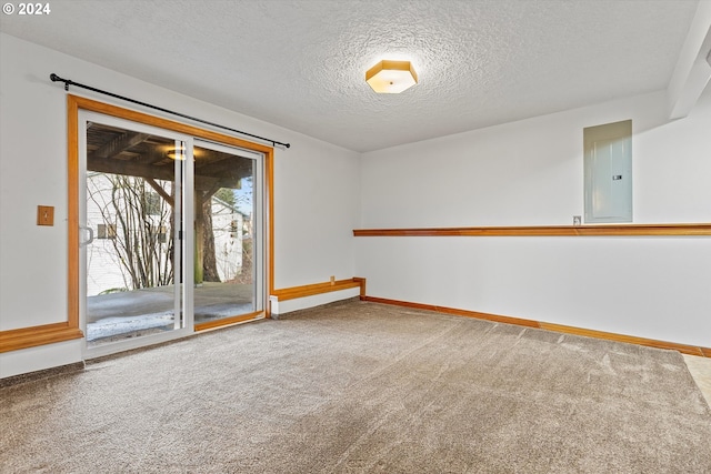 empty room with electric panel, carpet floors, and a textured ceiling