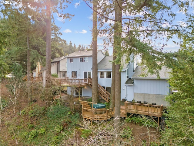 rear view of property with a wooden deck