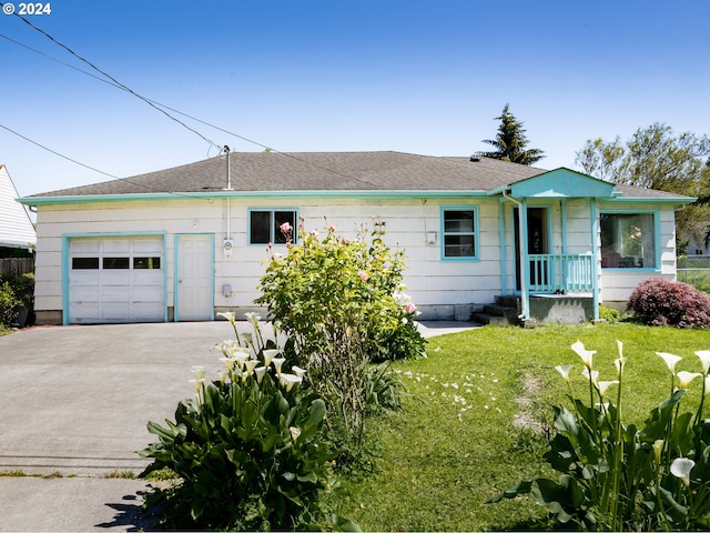 ranch-style house featuring a garage and a front lawn