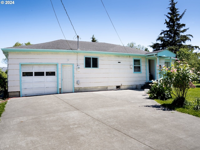 back of property featuring a garage