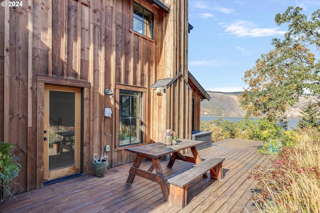 wooden terrace featuring a water view