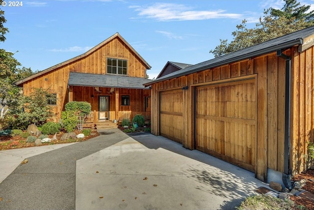 view of front of property featuring covered porch and a garage