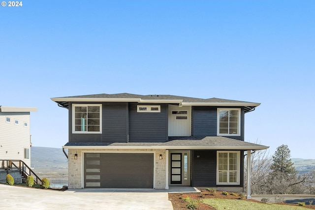 prairie-style house featuring driveway and an attached garage