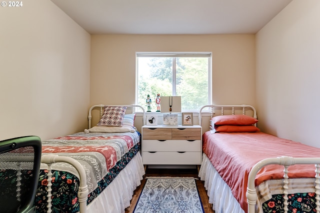 bedroom with dark wood-type flooring