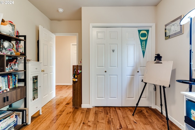 foyer entrance featuring baseboards and light wood finished floors