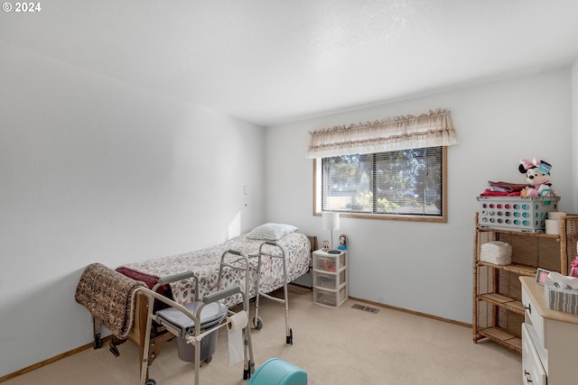 bedroom featuring light colored carpet