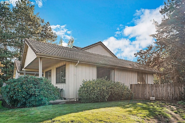 view of property exterior with a yard