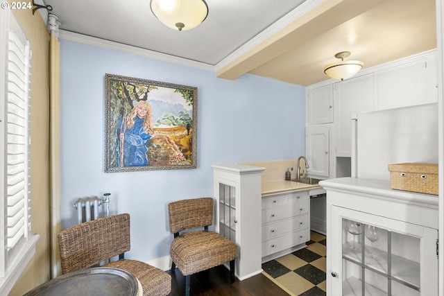 living area featuring sink, dark tile floors, built in desk, and crown molding