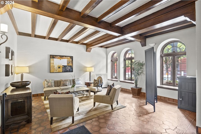 tiled living room with beam ceiling and french doors