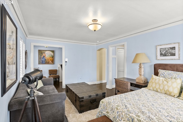 bedroom with hardwood / wood-style flooring and crown molding