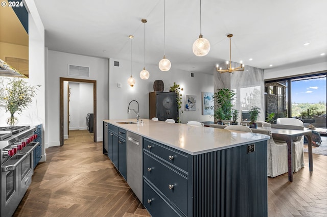 kitchen with an island with sink, stainless steel appliances, pendant lighting, and sink