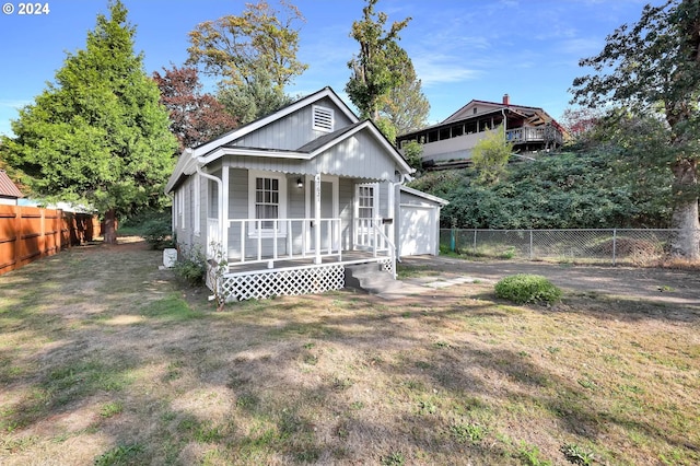 view of front of house with a front yard and a porch