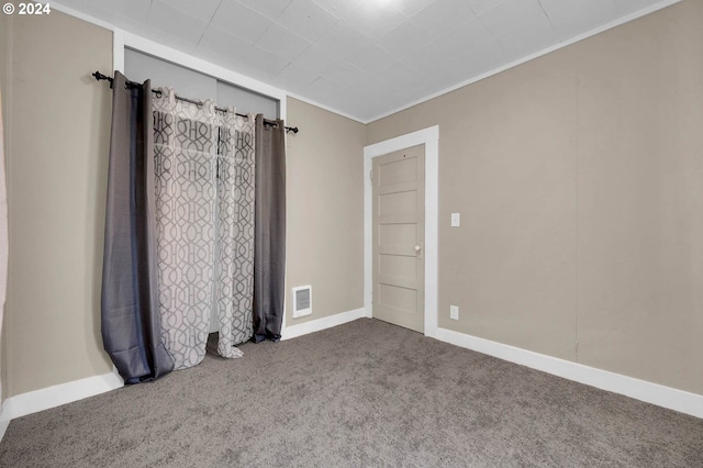 carpeted empty room with crown molding