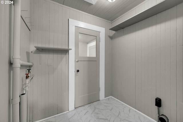 washroom with wood walls