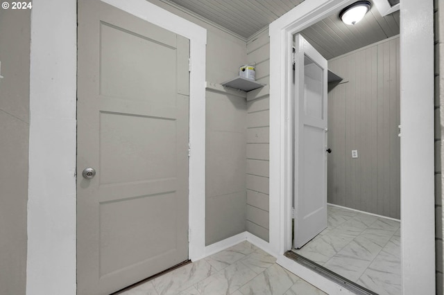 bathroom with wooden ceiling and wooden walls