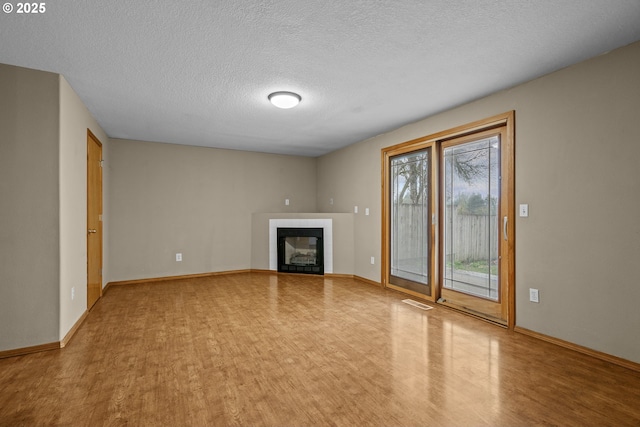 unfurnished living room with a textured ceiling