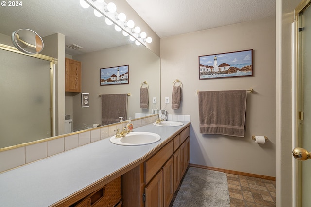 bathroom featuring a textured ceiling and vanity