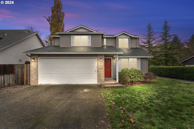 front facade featuring a yard and a garage