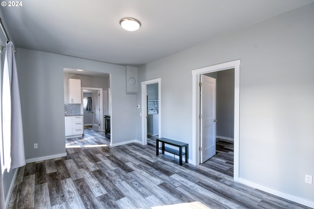 unfurnished room featuring washer / clothes dryer and dark hardwood / wood-style floors