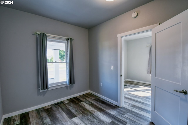 spare room featuring dark wood-type flooring